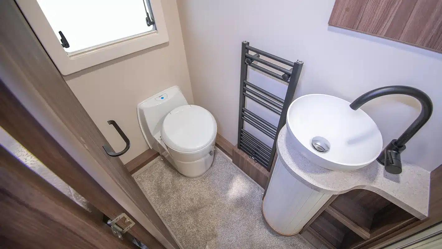 Badezimmer mit Toilette, rundem Waschbecken und Handtuchheizkörper im Auto-Sleepers Burford Duo Wohnmobil