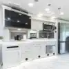 Helle, moderne Küche mit großen Schränken, Spüle, Mikrowelle, Kühlschrank und TV im Berkshire 39A Wohnmobil