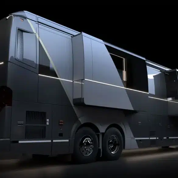Seitenansicht eines Elite H-Series Motorhomes auf Prevost H3-45 Chassis mit ausgefahrenen Slide-Outs und LED-Lichtakzenten bei Nacht