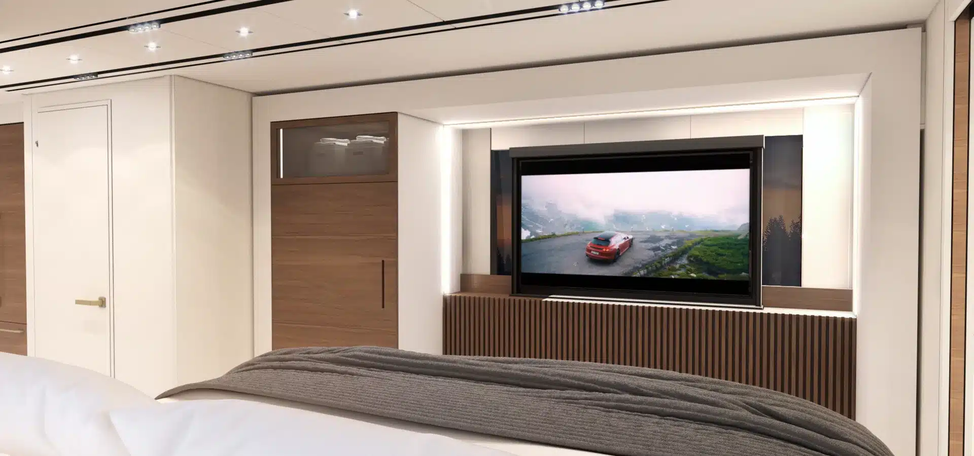 Innenansicht eines Elite H-Series Wohnmobils mit großem Fernseher, Holzverkleidung und modernen Einbauschränken