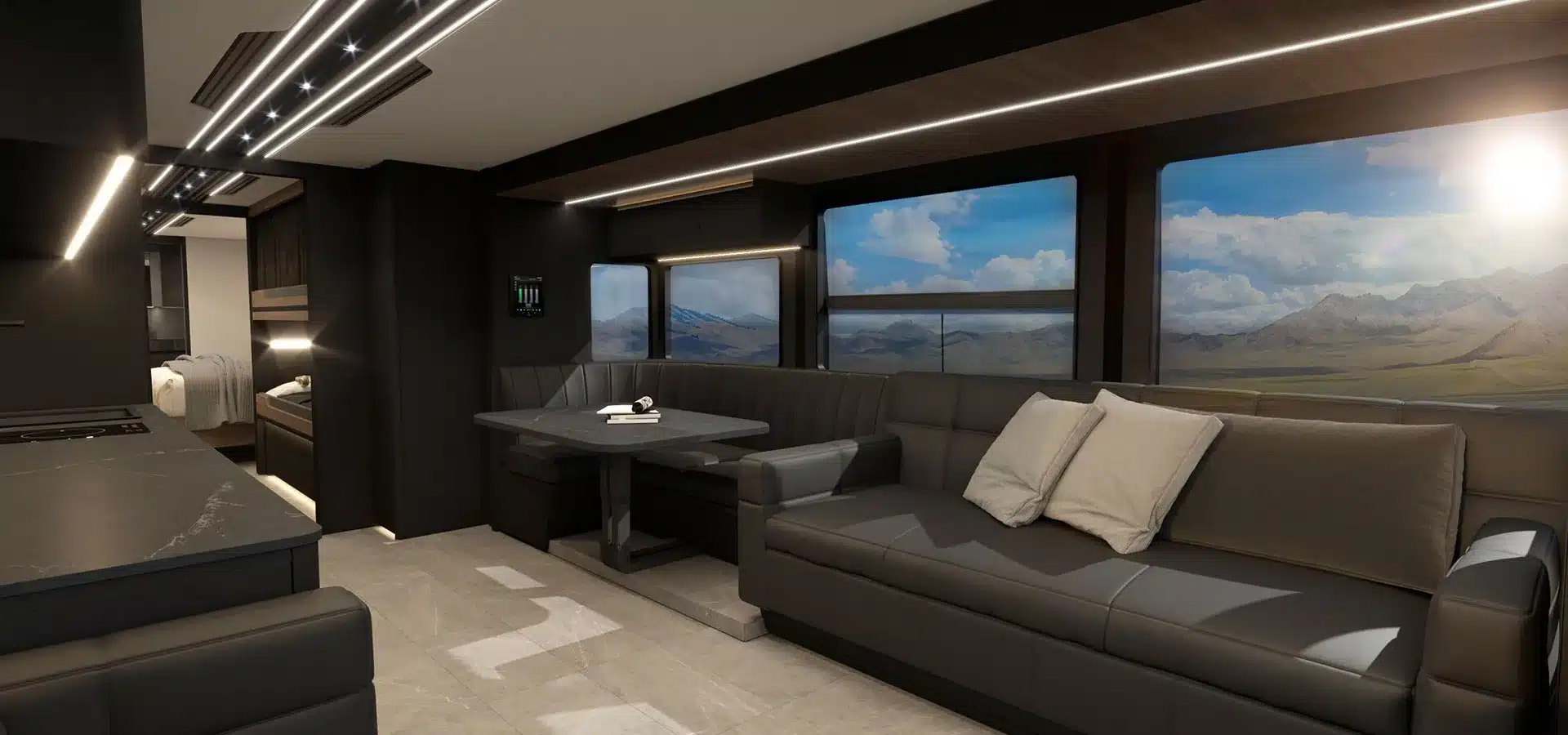 Innenraum des Elite H-Series Motorhome mit großer Sitzecke, Esstisch, Sofa und Panoramafenstern mit Blick auf Berge