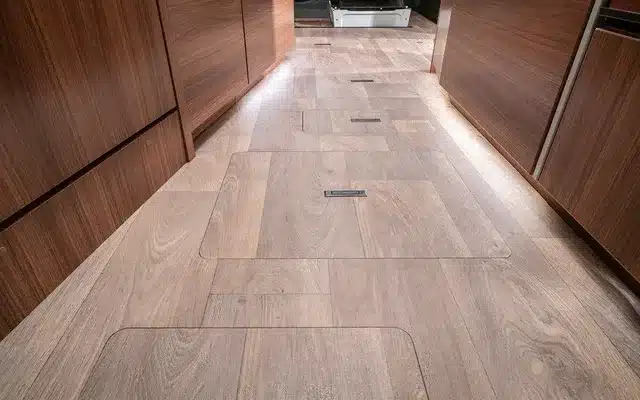Ebenboden im Innenraum eines HYMER B-Klasse MasterLine T Wohnmobils mit Holzoptik und Stauraumklappen