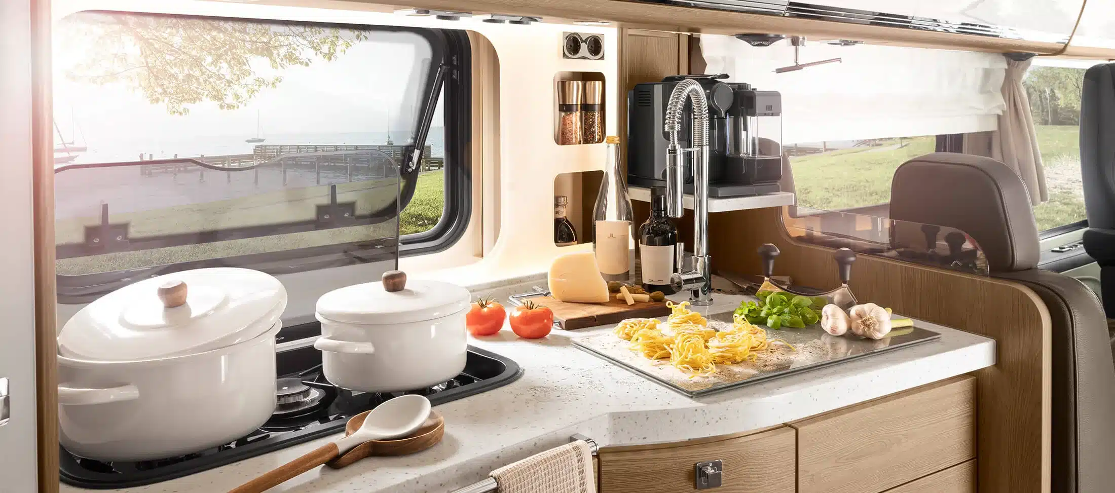 Moderne Küche mit Kochfeld, Spüle, Kaffeemaschine und frischen Zutaten im Morelo Empire Liner