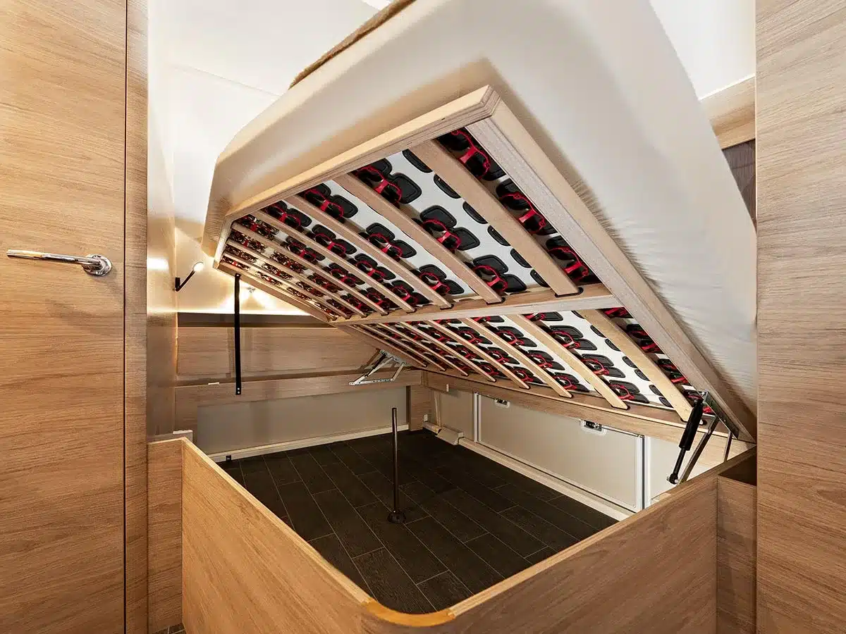 Aufgeklapptes Bett mit Tellerrost und großem Stauraum im Tabbert Pantiga Finest Edition Wohnwagen