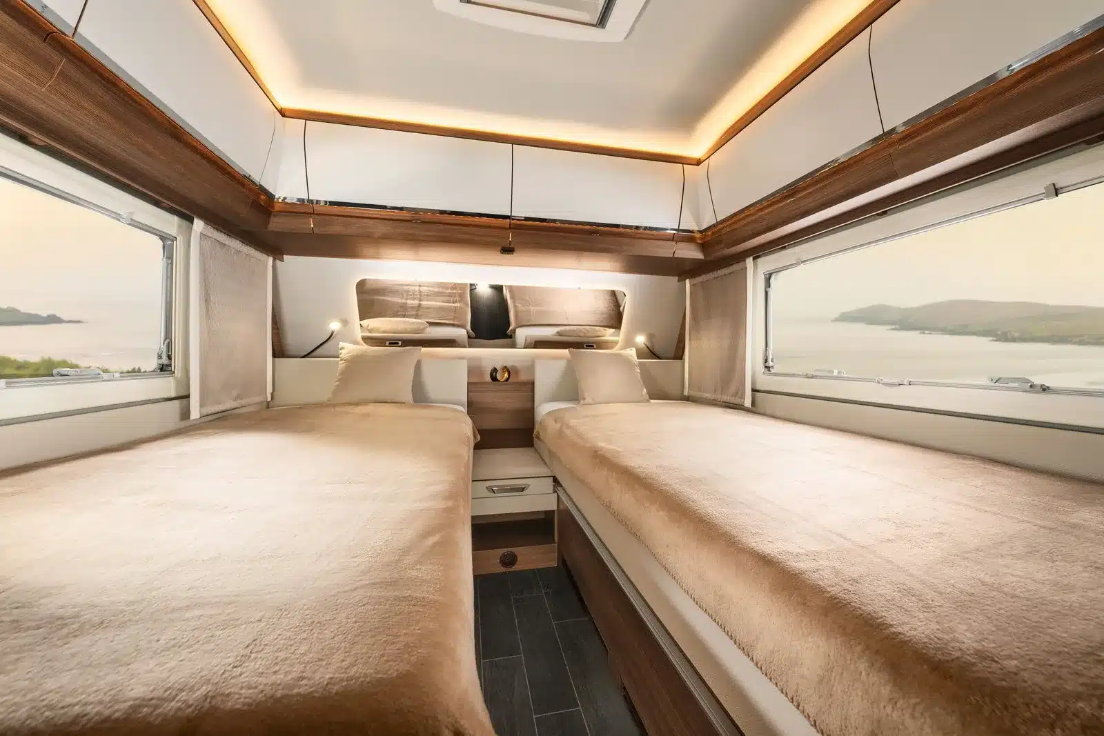 Innenansicht des Schlafbereichs im Tabbert Puccini Wohnwagen mit zwei breiten Einzelbetten, hochwertigem Lichtdesign und großen Fenstern