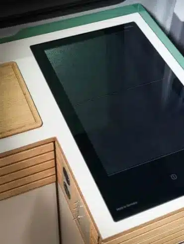 VANING Induktionskochfeld eingebaut in eine Campervan-Küche mit Holzarbeitsfläche