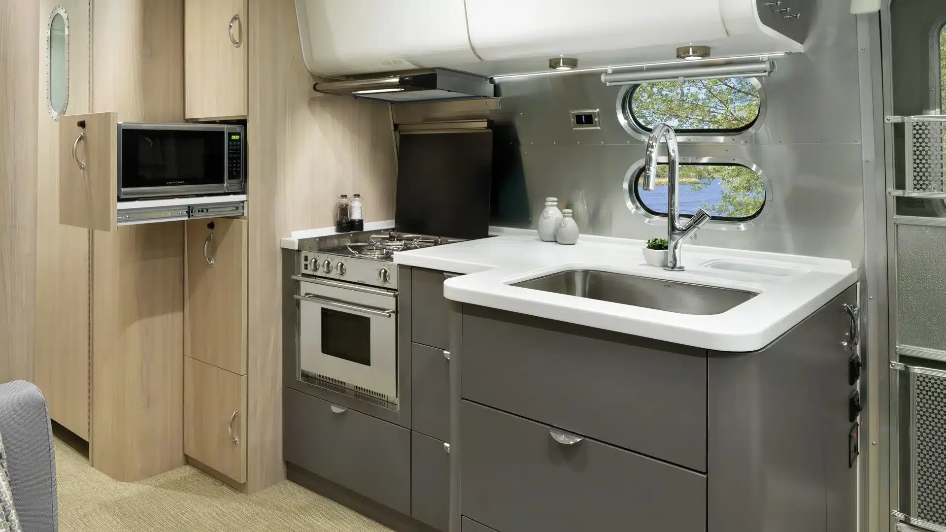 Küchenbereich eines Airstream Globetrotter mit Herd, Backofen, Mikrowelle und Waschbecken