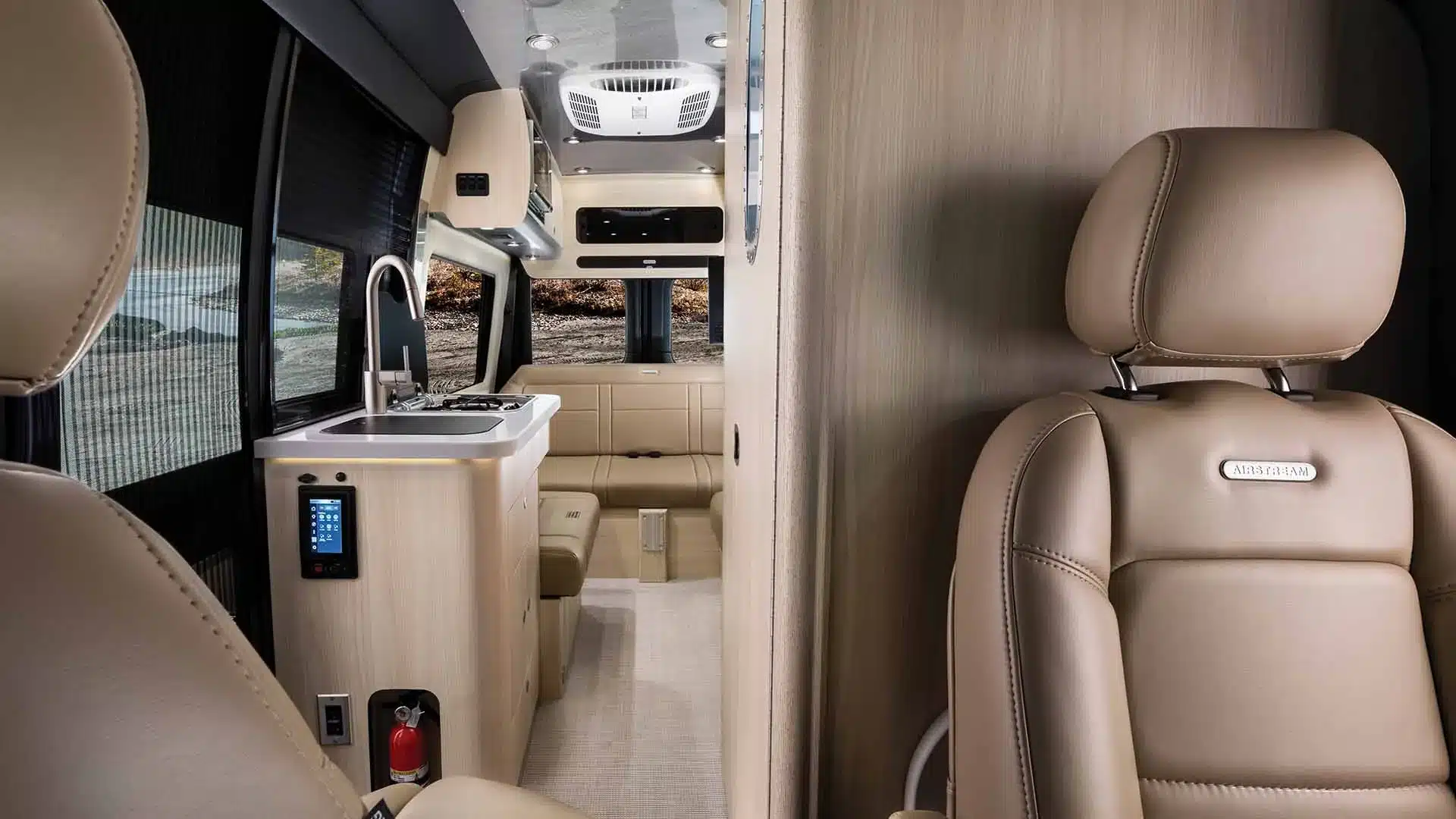 Innenansicht des Airstream Interstate 19GTX mit Sitzbereich, Küchenzeile und modernem Camper-Ambiente.