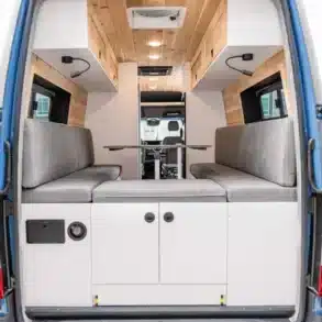 Innenansicht eines Cape Breton Campervans mit Sitzbänken, Tisch, Holzverkleidung und Stauraum