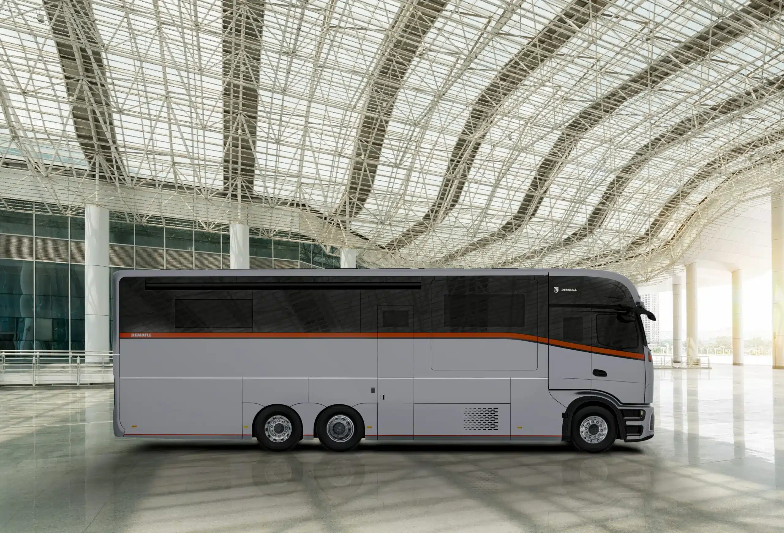 Seitenansicht des Dembell Elite Luxusreisemobils mit großer Garage, abgestellt in moderner Halle