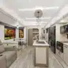 Innenraum des Essence E-28RL Fifth-Wheel mit moderner Küche, Sitzbereich und großen Fenstern