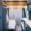 Innenansicht eines ausgebauten Driftwood-Campers auf Mercedes Sprinter-Basis mit modernen Möbeln und hellem Design.