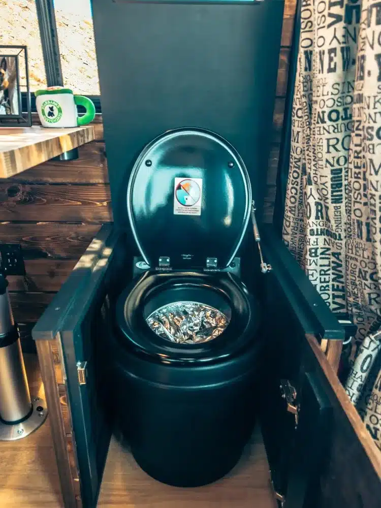 Detailansicht einer modernen Komposttoilette im ausgebauten Campervan mit Holzinterieur