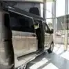 Ford Transit Custom Camper mit Aufstelldach seitlich im Ford-Autohaus ausgestellt