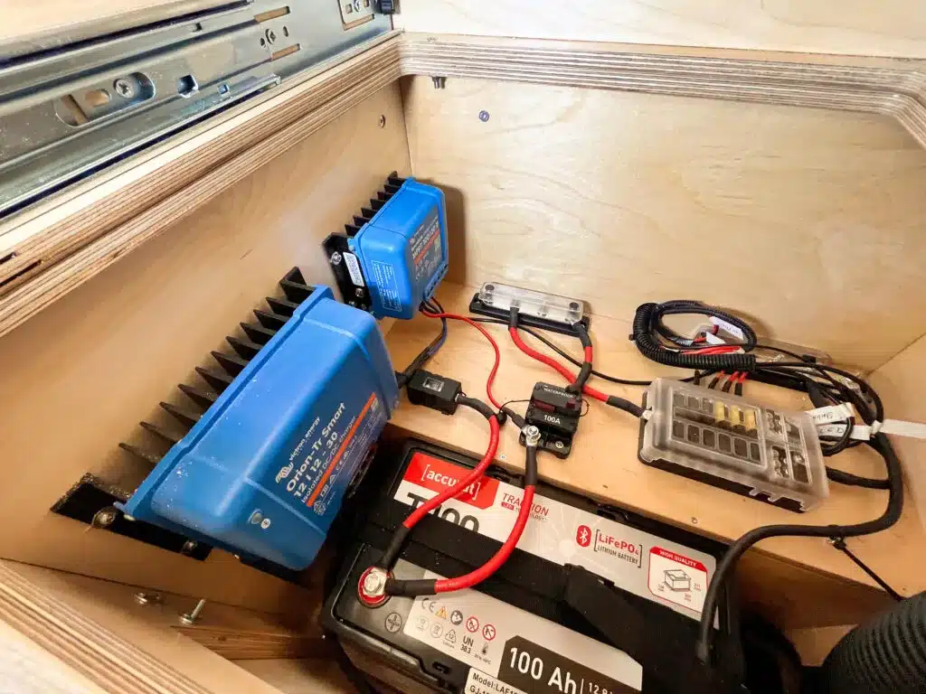 Detailansicht der elektrischen Anlage mit 100 Ah Lithium-Batterie und Verteilpanel im Defender 130 Pickup Camper.