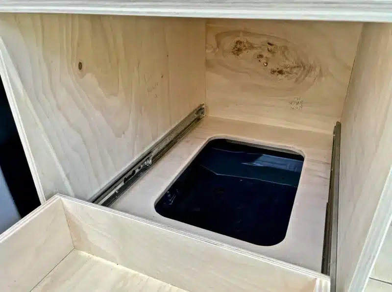 Offenes Staufach mit Auszugschienen im Holz-Innenausbau eines Toyota Highlander Campers