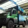 Expeditionsfahrzeug Laske LE410 mit Parallel-Hubdach und Hardwall-Kabine in einer Werkshalle, grün-blau lackiert auf Basis Iveco Daily 4x4.