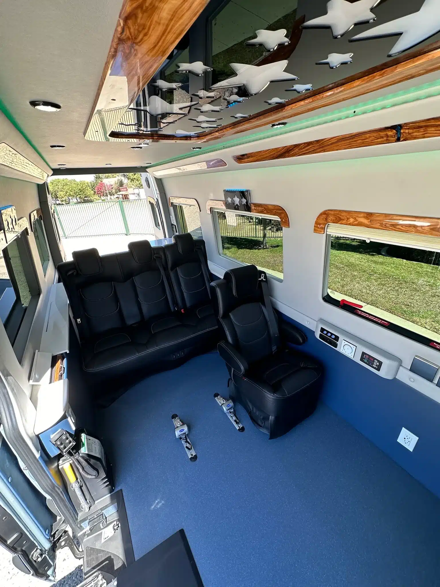Barrierefreier Innenraum eines Mobility Van Ability Star mit Ledersitzen, Rollstuhl-Bodenverankerungen und moderner Beleuchtung.