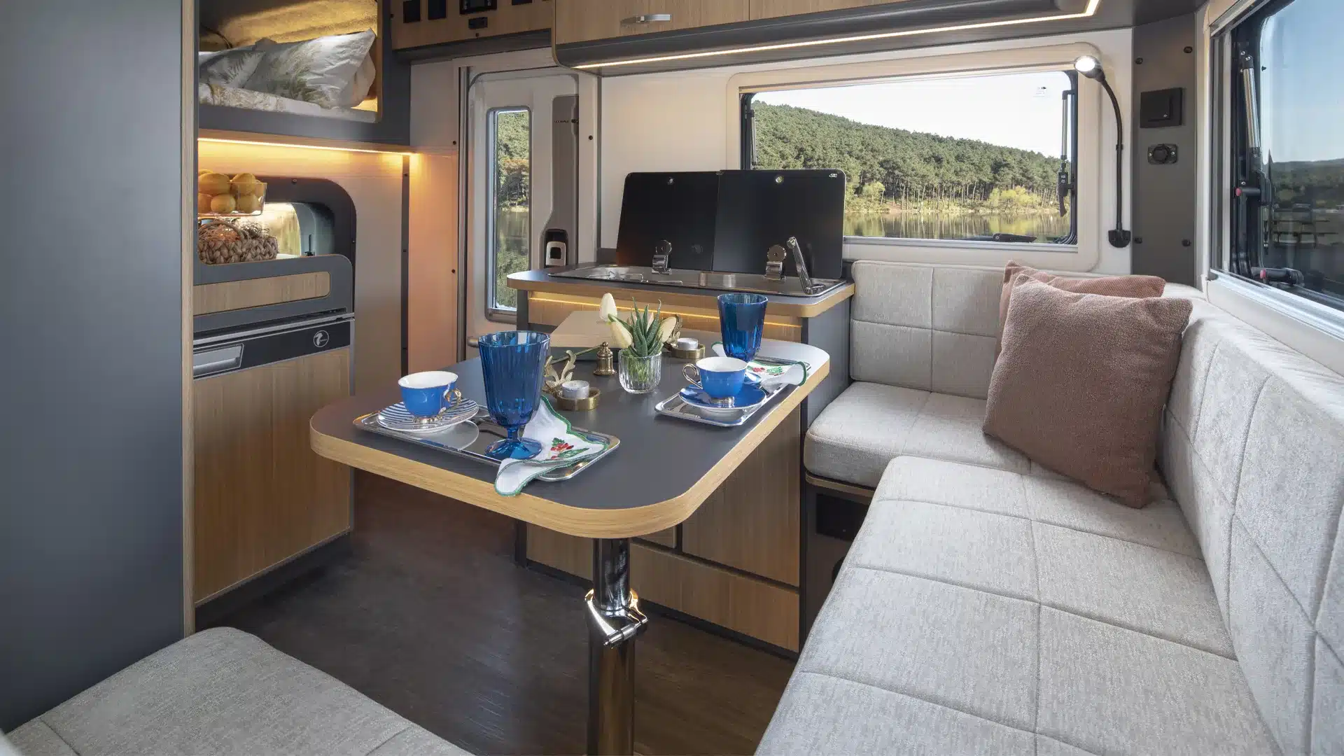 Innenansicht des Ronin XL Wohnmobils mit Sitzgruppe, Esstisch und Küchenzeile