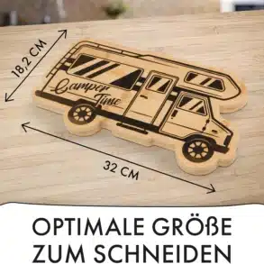 Bambus-Schneidebrett in Form eines Wohnmobils mit den Maßen 32 x 18,2 cm und Gravur 'Camper Time', auf einer hellen Holzoberfläche liegend