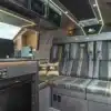 Wohnbereich mit exklusiver Polsterung und Kücheneinheit im John McGuinness Edition Campervan von AB Race Cruisers