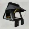 Geöffnetes Nomad Dachzelt mit LED-Leiste und schwarzem Außentuch vor hellem Hintergrund.