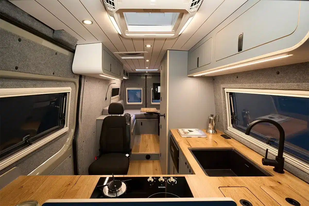 Innenansicht des Bunnylounge 2.0 Campers mit Küche, Sitzgruppe und Stauraum auf Mercedes-Benz Sprinter-Basis