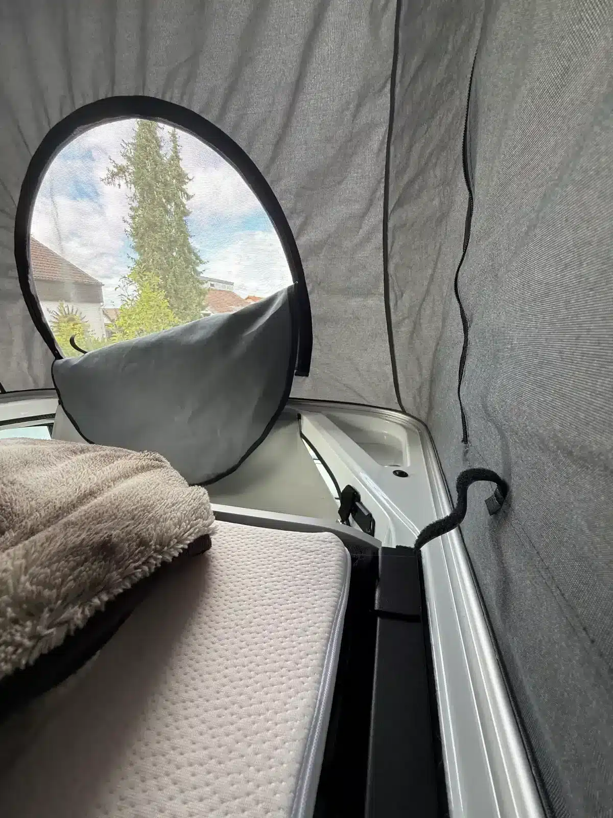 Innenansicht des Aufstelldachs mit Bett und Fenster im Mooveo Campervan 2.