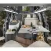 Innenraum des Dreamer Cap Land Campervans mit eingerichteter Sitzgruppe und Tisch