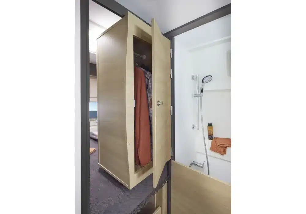Blick auf den drehbaren Kleiderschrank und die Dusche im Kastenwagen Dreamer D55.