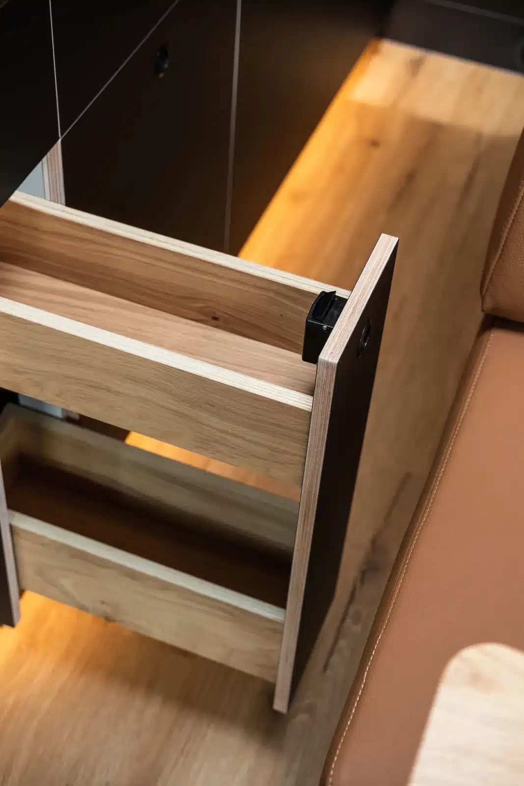 Detailansicht eines ausziehbaren Apothekerschranks aus Holz im Campervan Nautilus.