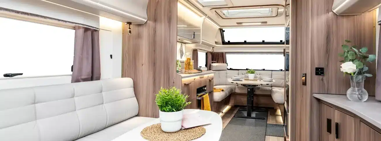 Moderner, großzügiger Wohnbereich und Küche im KABE Imperial 1000 TDL Caravan mit hellen Möbeln und Dekoration.