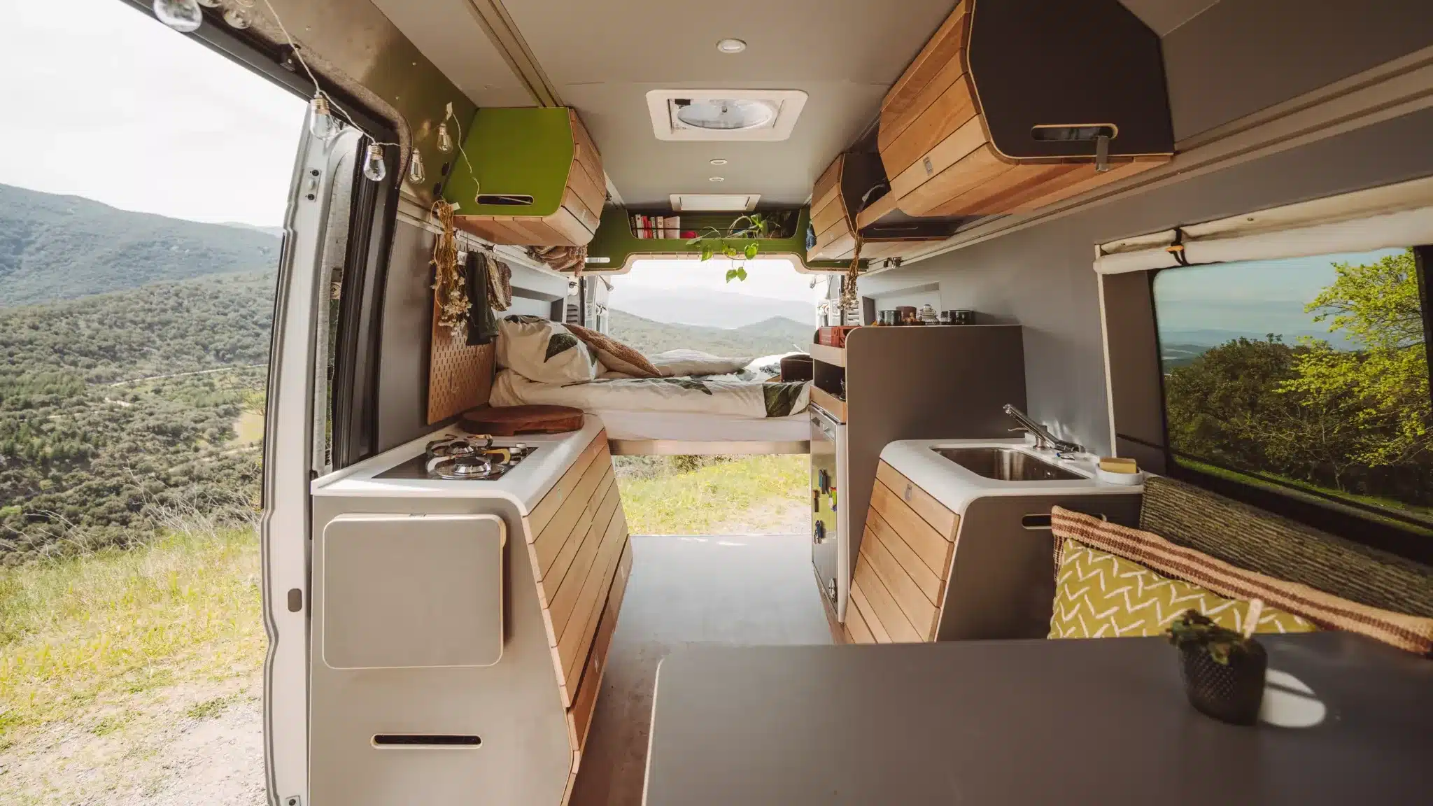 Innenraum eines VAN-Jorn Family Campers mit Bett, Küche und viel Stauraum, ausgebaut auf Peugeot Boxer L3H2
