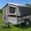 Graues Roof Lodge Trailer Tent auf einem Metallanhänger im Grünen